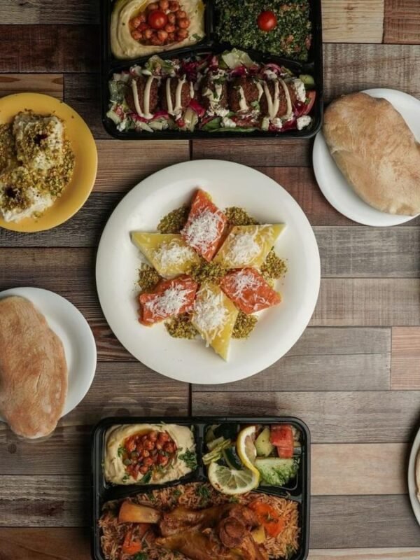 Mediterranean catering spread with mezze, salads, plates and desserts